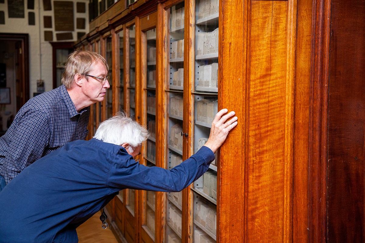 Dr Nigel Woodcock and a CPS member explore specimens from the Watson Building Stones Collection, Department of Earth Sciences.
